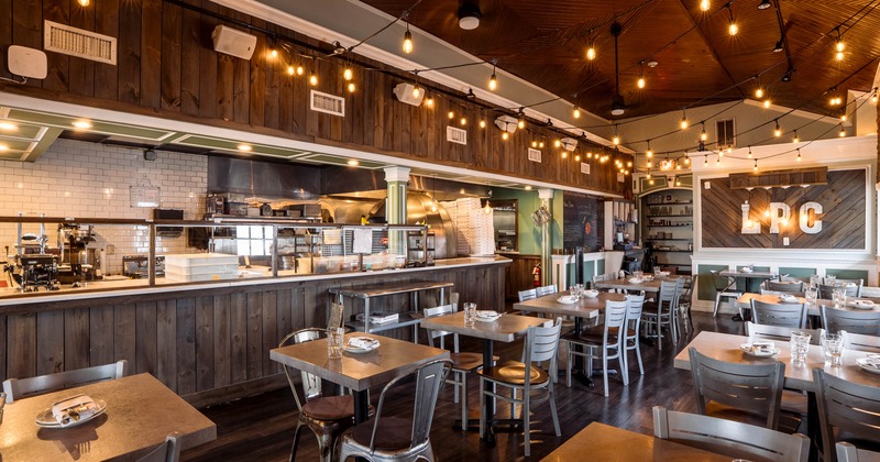 Interior, dining area, tables with chairs, kitchen and display cases