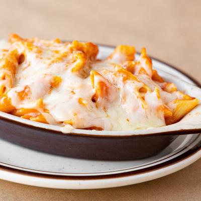 Baked ziti in a brown dish.