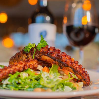 Braised octopus over a mixed salad