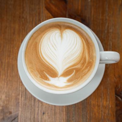 A cup of latte with heart art.