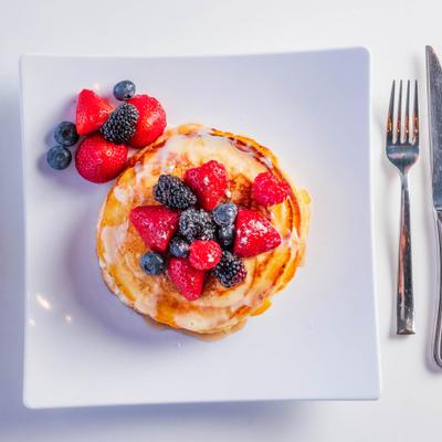 Tres Leche pancakes topped with fresh berries.