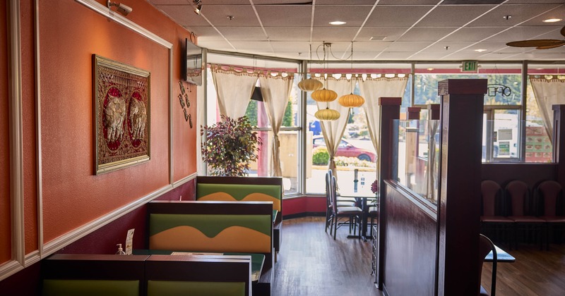 Interior, dining area, seating booths with tables, wooden room dividers, shop window in the back