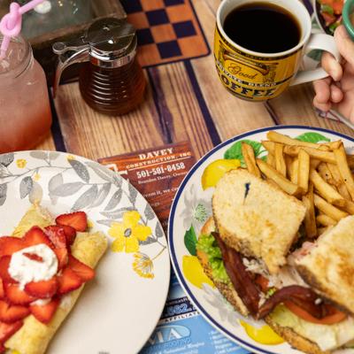 Strawberry crepes, club sandwiches, and coffee.