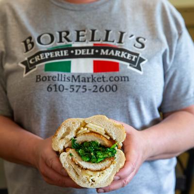 A person holding the Italian chicken sandwich.