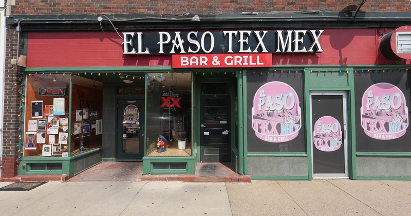 Exterior, front view to restaurant entrance, sign, sidewalk