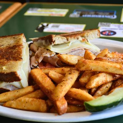 Ham and cheese sandwiches, with fries.