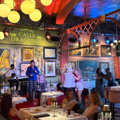 Some guests dancing, others having brunch and the band is playing in the back.