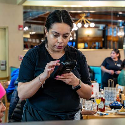 Restaurant server using a handheld ordering device.