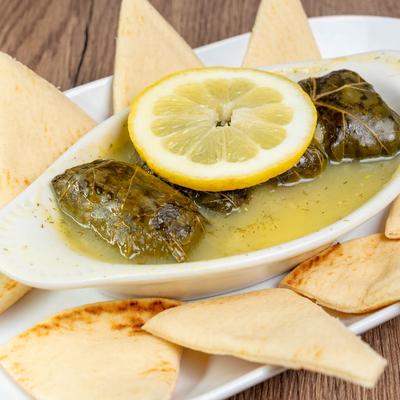 Stuffed grape leaves and pita bread, close up.