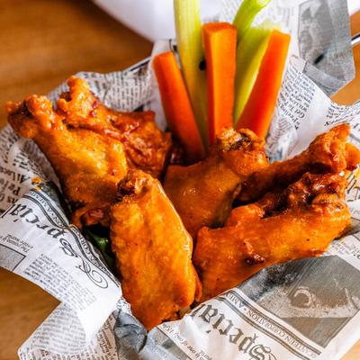 Buffalo wings with celery and carrot sticks.