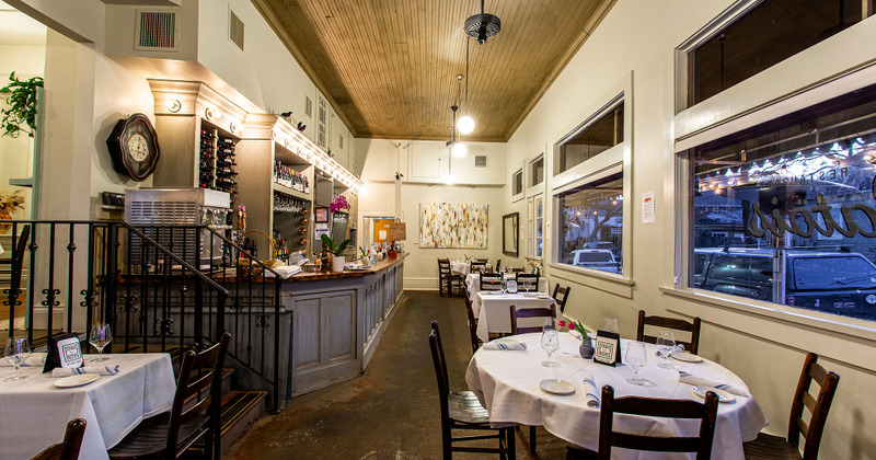 Interior - tables ready for guests, pictures on the walls