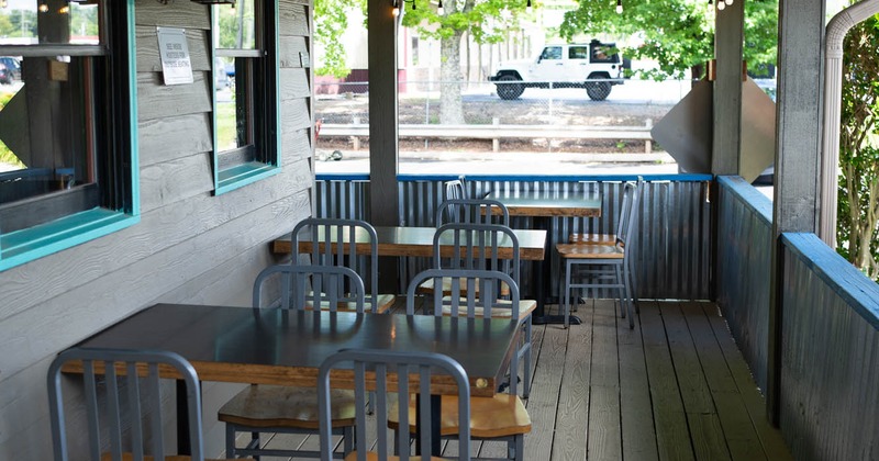 Outdoor, covered terrace with tables and chairs