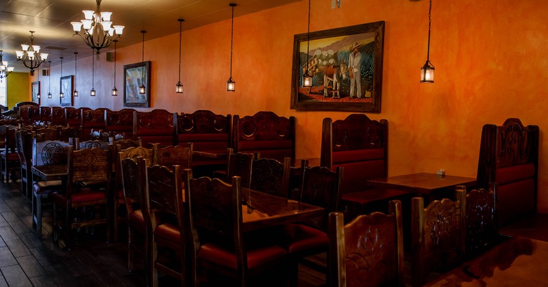 A seating area with a row of booths against the wall