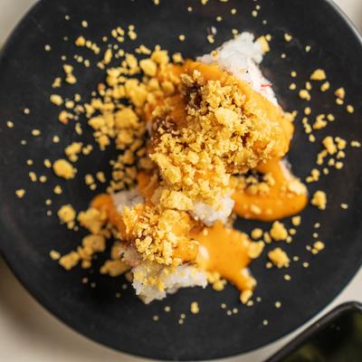 Sushi rolls with spicy sauce and crunch.