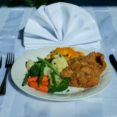 Southern fried chicken with sides, served on the table.