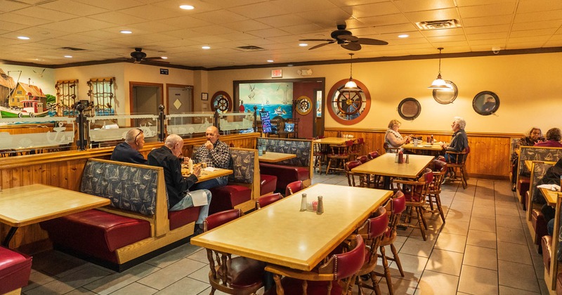 Dining area, booths, and tables with chairs