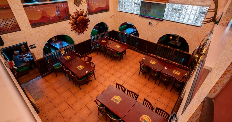 Interior with tiled floors, wooden tables and decorative walls with archways, top view