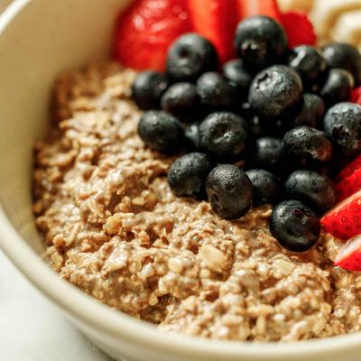 Close view of oatmeal topped with berries and bananas.