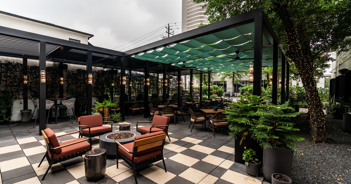 Exterior, patio with tables, chairs, plants and a canopy
