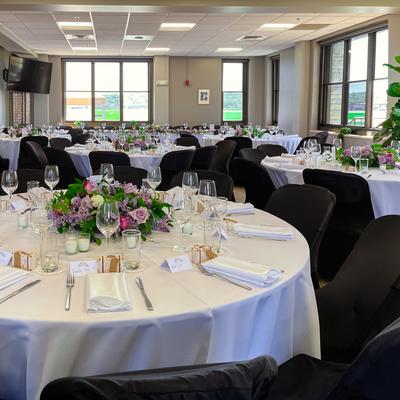 Interior, dining area, round tables with floral centerpiece