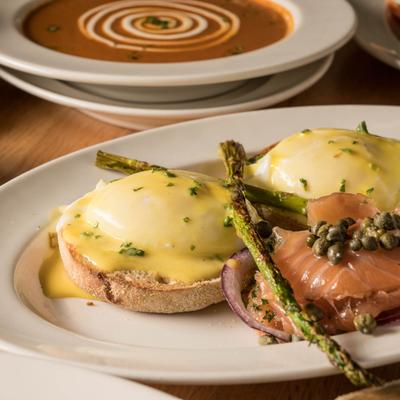 Cured Salmon Benedict with polenta cakes,  garnished with capers and asparagus.
