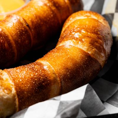 Breadsticks served with a dip, close-up.