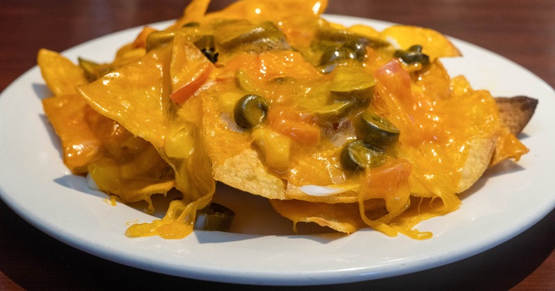 Loaded Nachos, with cheddar, tomatoes, olives, onions, and jalapenos