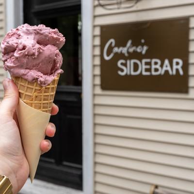 A purple scoop of ice cream on a waffle cone from Caroline's Sidebar.