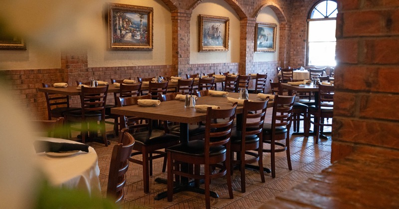 Interior, tables and chairs, wide view to a diner area