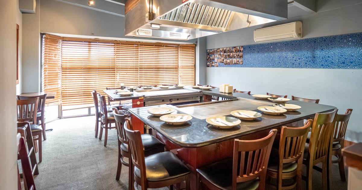 Interior, seating area with a place for cooking at the tables