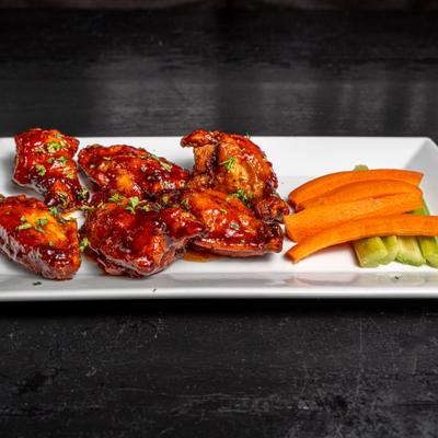 Portion of wings served with vegetable sticks.