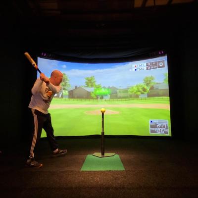 Person hitting a baseball off of a tee.
