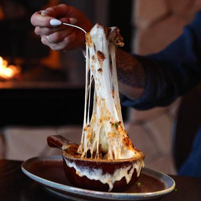 French onion soup, cheese pull shot.