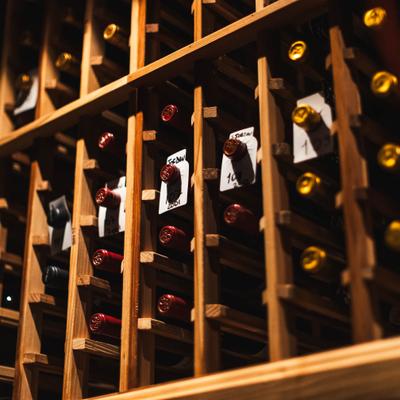 Wooden wine rack filled with assorted bottles.