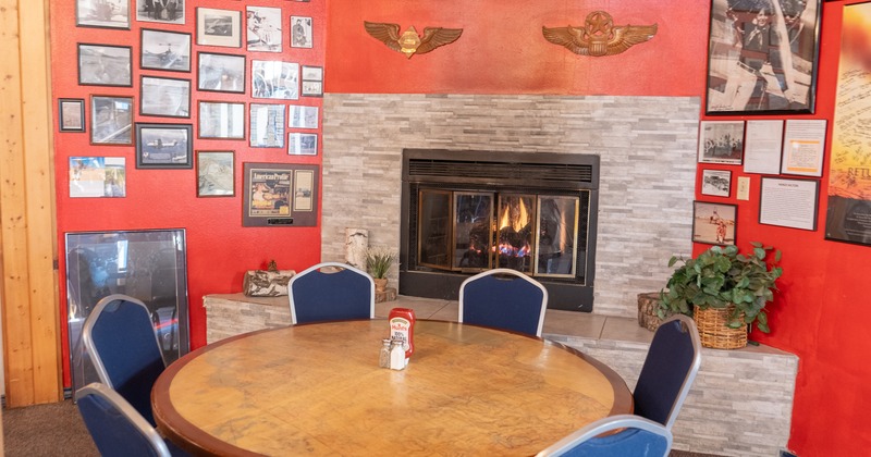 Diner table, chairs, fire place behind