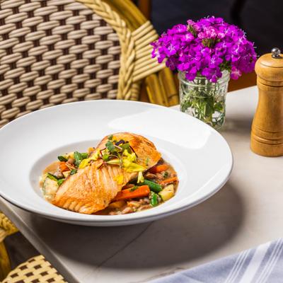 Grilled salmon and vegetables served in a bowl.
