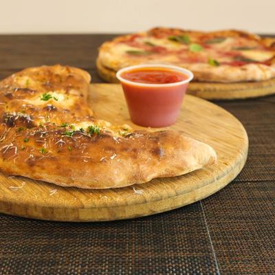 Calzone with marinara sauce.