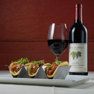 Wine bottle, wine glass, and short rib street tacos