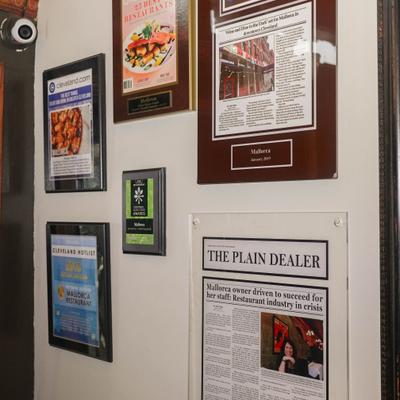 Wall covered with framed awards and newspaper articles.