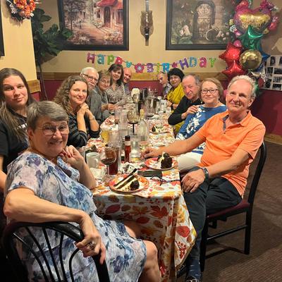 A group of patrons  posing for a shot at a table in the restaurant.