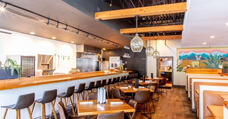 Interior, food counter and dining area with tables and booths