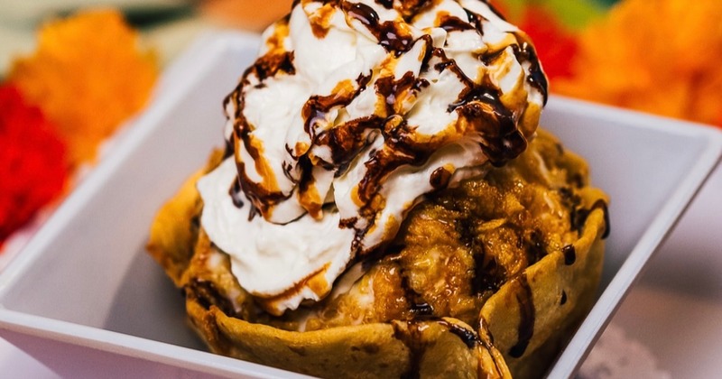 Fried ice cream topped with whipped cream and chocolate and caramel sauces