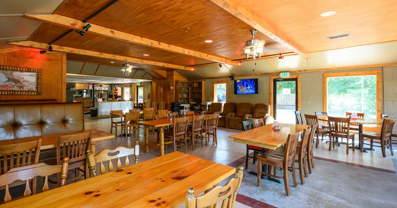 Interior - wooden tables, leather bench seating and a cozy seating area with armchairs.