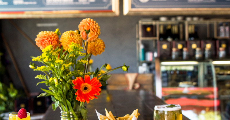 Glass of beer and fries on table