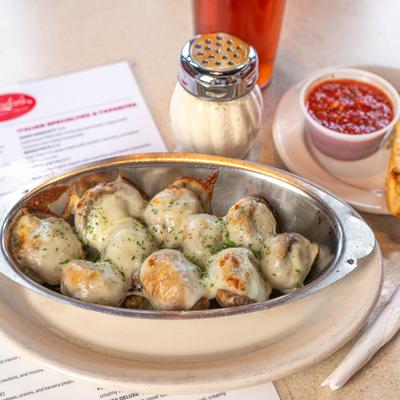 Stuffed mushrooms topped with melted cheese, served with marinara sauce and Parmesan.