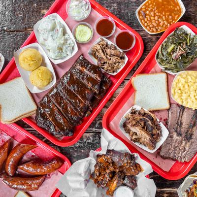 Assorted BBQ plates and platters, overhead view.