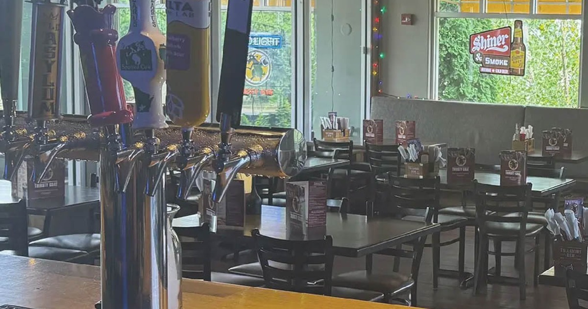 Bar counter with beer taps and view of the dining room