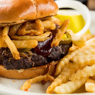 Char-grilled burger topped with onion, bacon and cheddar, served with fries