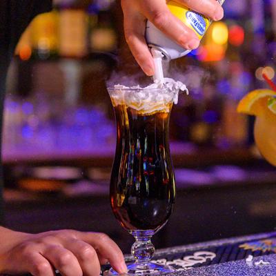 Hands preparing a beverage.