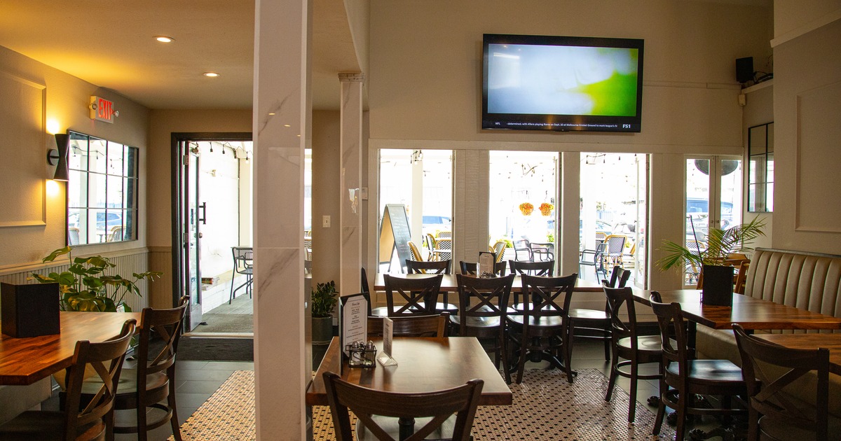Diner area, tables, chairs, tv screen above